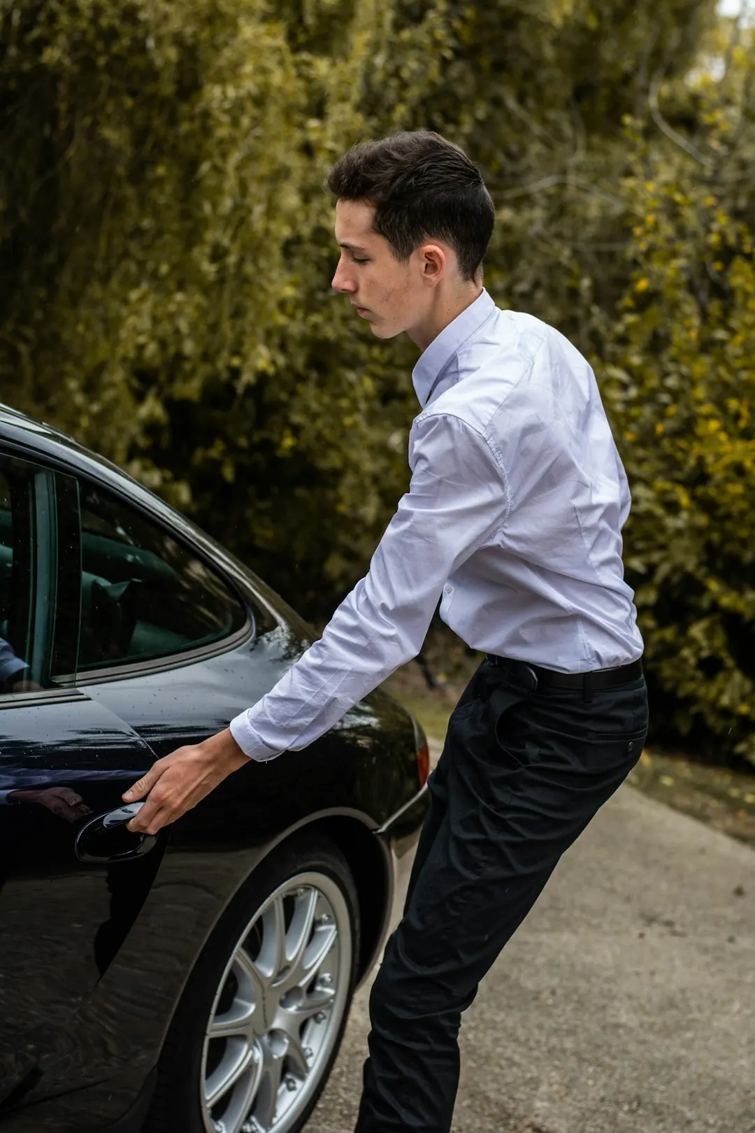 Chauffeur holding the car door for a business client on an hourly booking